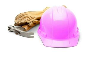 Pink Safety Construction Hard Hat, Hammer and Leather Gloves Isolated on a White Background. photo