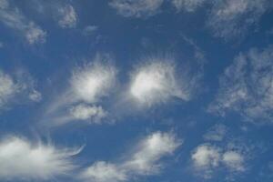 blue sky with white original clouds forming an interesting pattern photo