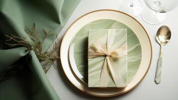 Two plates with gift wrapped on them, with a wine glass. photo