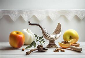 Shofar and other Rosh Hashanah holiday attributes on white wooden table indoors . . photo