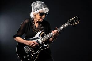 Portrait of a cool trendy old woman playing a guitar on black studio background. AI Generated photo