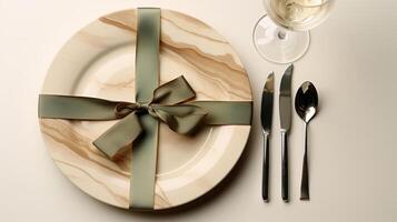 Two plates with gift wrapped on them, with a wine glass. photo