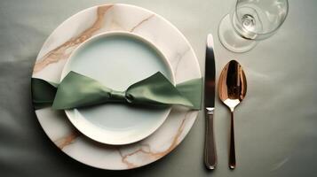 Two plates with gift wrapped on them, with a wine glass. photo