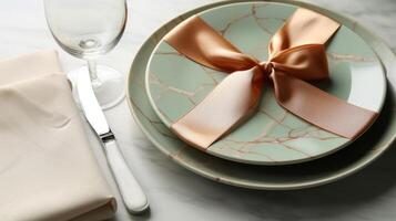 Two plates with gift wrapped on them, with a wine glass. photo