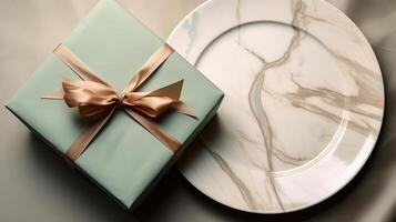 Two plates with gift wrapped on them, with a wine glass. photo