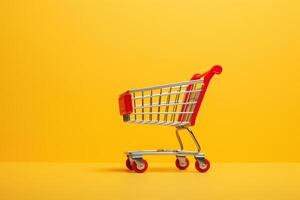red shopping cart on yellow background. photo