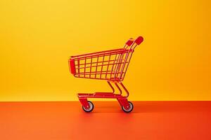 red shopping cart on yellow background. photo
