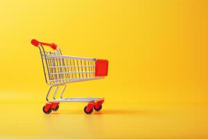 red shopping cart on yellow background. photo