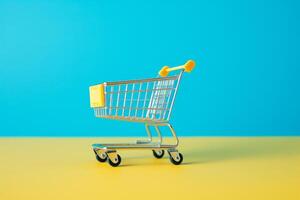 yellow shopping cart on blue background. photo