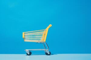 yellow shopping cart on blue background. photo