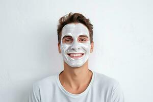 portrait of a smiling happy young man smiling while pampering his skin with a face mask on white background. AI Generated photo