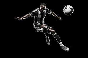 soccer player in mid air kicking ball on a black background . photo