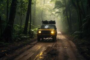 Four wheel drive SUV is driving on muddy road in jungle. photo