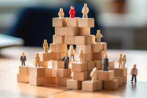 Small people figures on wooden cubes. Teamwork and development. photo