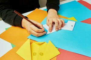 Boy making paper dog origami photo