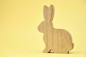 Happy Easter decoration, Wooden rabbit on yellow background photo