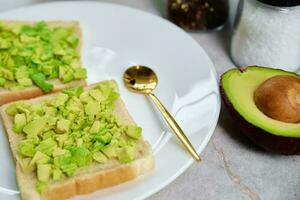 Toasts with avocado on plate, Healthy nutrition photo