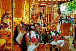 Horse carousel at amusement park photo