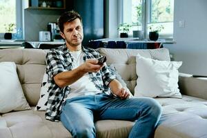 Man watching TV at home photo