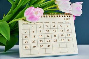 Calendar and flowers close up photo