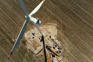 Construction site near windmill turbine, Wind generator installing photo