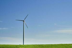 Wind turbine in the field. Wind power energy concept photo