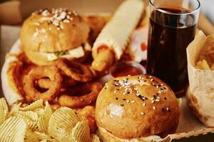 Unhealthy and junk food. Different types of fast food on the table, closeup photo