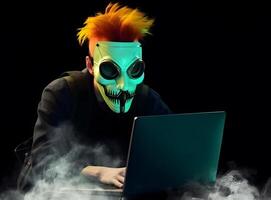 Anonymous hacker using computer. Concept of dark web, cybercrime, cyberattack. photo