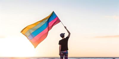 Boy waving rainbow flag. Concept of LGBT pride. photo