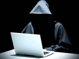 Hacker typing laptop. Concept of cybercrime, cyberattack, dark web. photo