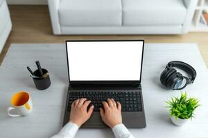 Laptop computer with isolated display on office desk. Top view composition photo