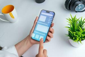 Woman holding a smartphone with a conceptual user interface. The interface showcases a clean design with vibrant colors and intuitive navigation elements photo