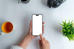 Top view, flat lay smart phone mockup in hands. Office work desk. Business composition photo