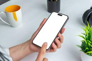 Smartphone mockup. Women hand using mobile phone. White screen isolated for app presentation. Office desk photo
