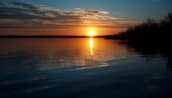 Golden sun sets over tranquil water surface photo