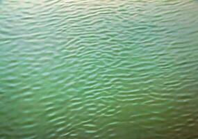 The texture of the water of the river. Natural water background with ripples and waves. photo