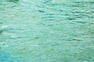 The texture of the water of the river. Natural water background with ripples and waves. photo