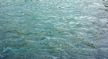 The texture of the water of the river. Natural water background with ripples and waves. photo