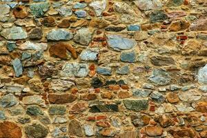 The texture of the stone wall. Background texture of the stone wall of the old castle. Stone wall as background or texture. photo