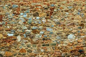 The texture of the stone wall. Background texture of the stone wall of the old castle. Stone wall as background or texture. photo