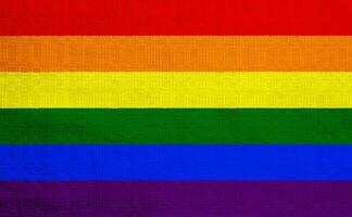 bandera de el lgbt comunidad en el antecedentes de un tela textura. arco iris símbolo de gay cultura. concepto collage. ilustración símbolo de orgullo. foto