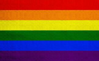 Flag of the LGBT community on the background of a fabric texture. Rainbow symbol of gay culture. Concept collage. Illustration symbol of pride. photo
