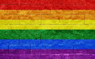 Flag of the LGBT community on the background of a stone wall. Rainbow symbol of gay culture. Concept collage. Illustration symbol of pride. photo