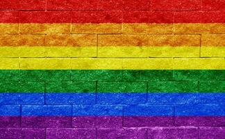 Flag of the LGBT community on the background of a stone wall. Rainbow symbol of gay culture. Concept collage. Illustration symbol of pride. photo