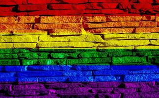 Flag of the LGBT community on the background of a stone wall. Rainbow symbol of gay culture. Concept collage. Illustration symbol of pride. photo