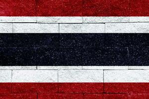 Flag of the Kingdom of Thailand on a textured background. Concept collage. photo