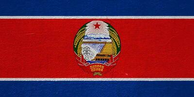 Flag of Democratic People's Republic of Korea or North Korea on a textured background. Concept collage. photo