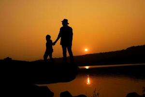 Silhouette of a person on a rock near the reservoir photo