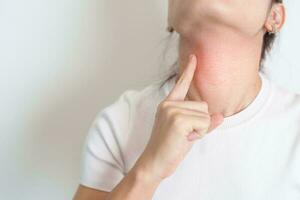 Woman checking Thyroid gland disease. Hand holding Neck pain. Hyperthyroidism, Hypothyroidism, Hashimoto Thyroiditis, Thyroid Tumor and Cancer, Postpartum, Papillary Carcinoma and Health concept photo