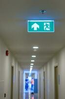 Fire Emergency exit sign on the wall background inside building. Safety concept photo